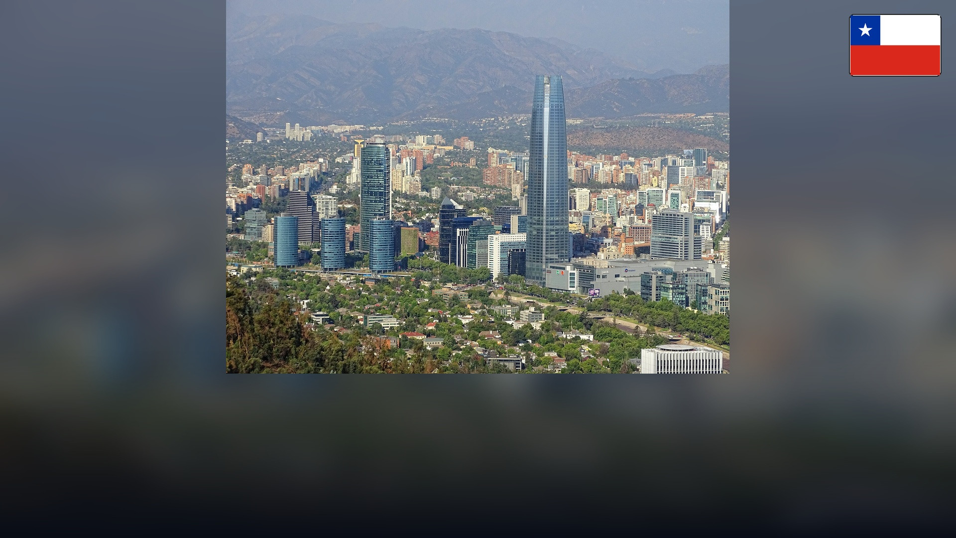 Gran Torre Santiago skyline with the Andes mountains and the Chilean flag in the top right corner.