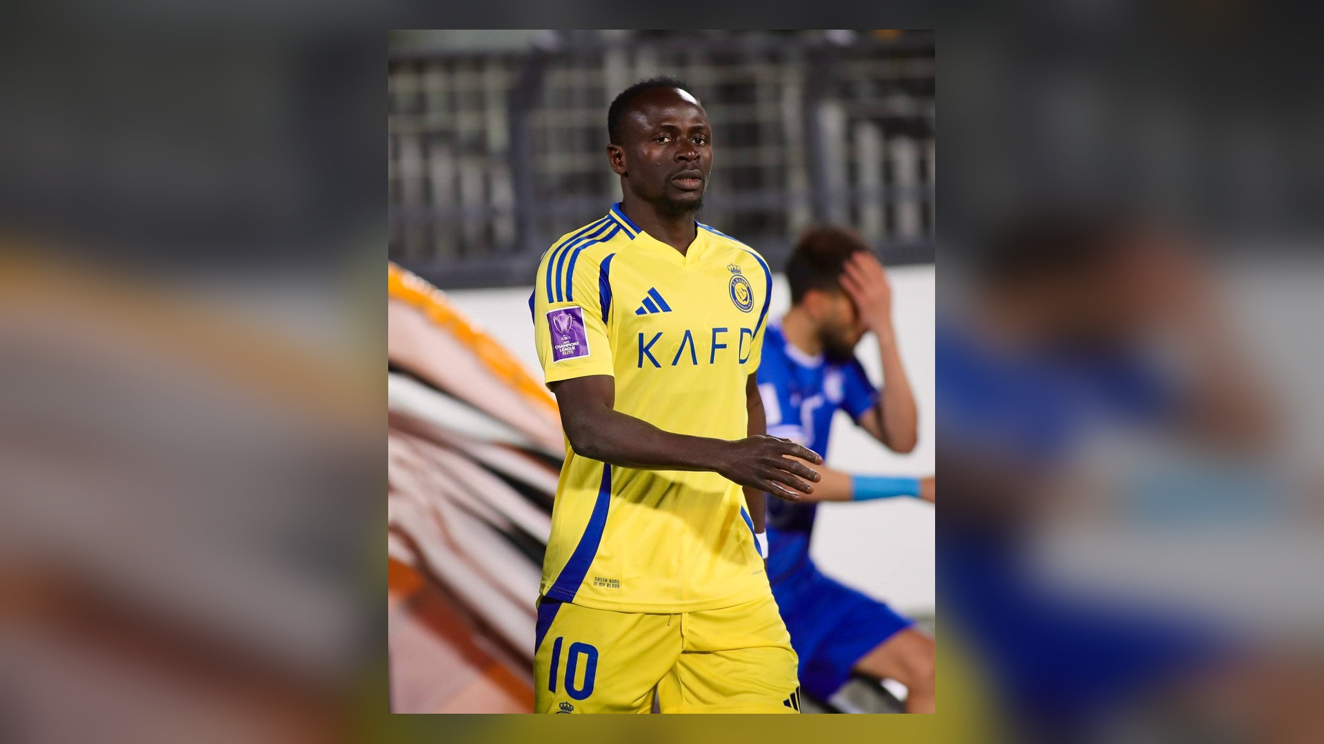 Sadio Mané in yellow Al Nassr kit on the pitch.