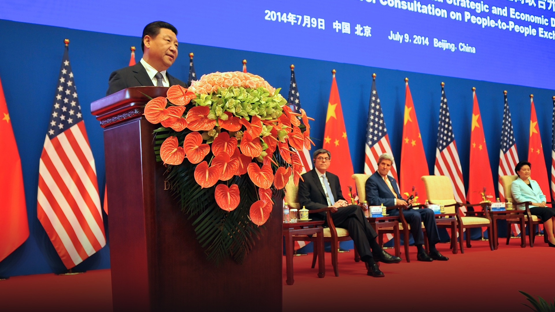 President Xi Jinping standing at the presidential podium delivering an official address in Beijing.