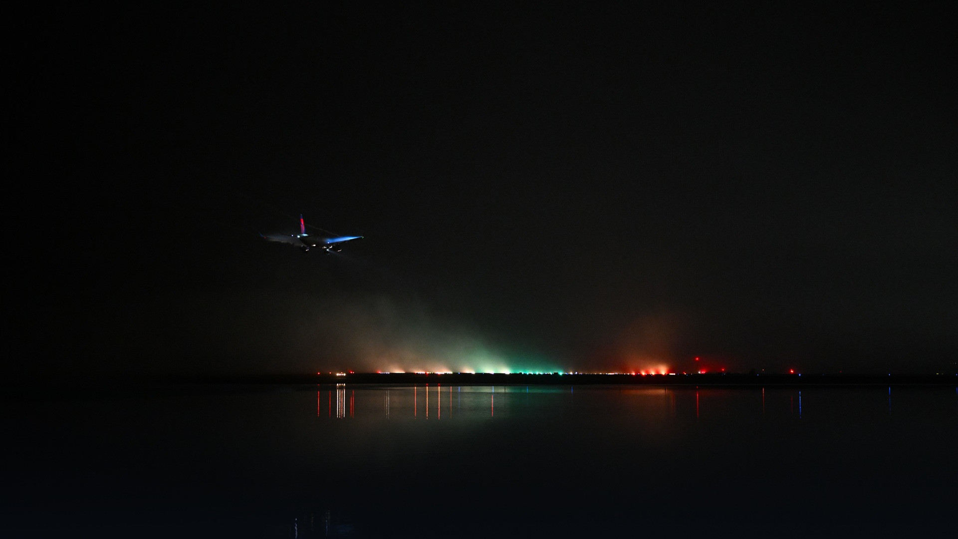 Passenger aircraft landing on foggy airport runway equipped with in-flight picocells.