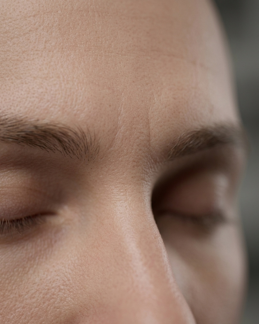 Close-up shot of the forehead and brow area, showing the smooth skin between the eyebrows.