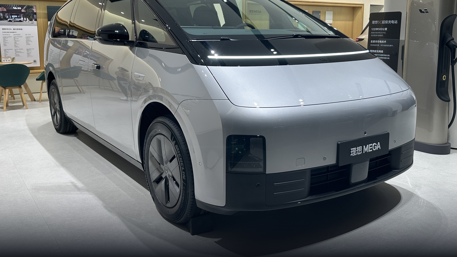 Sleek futuristic aerodynamic Li Auto MEGA flagship electric MPV in showroom.