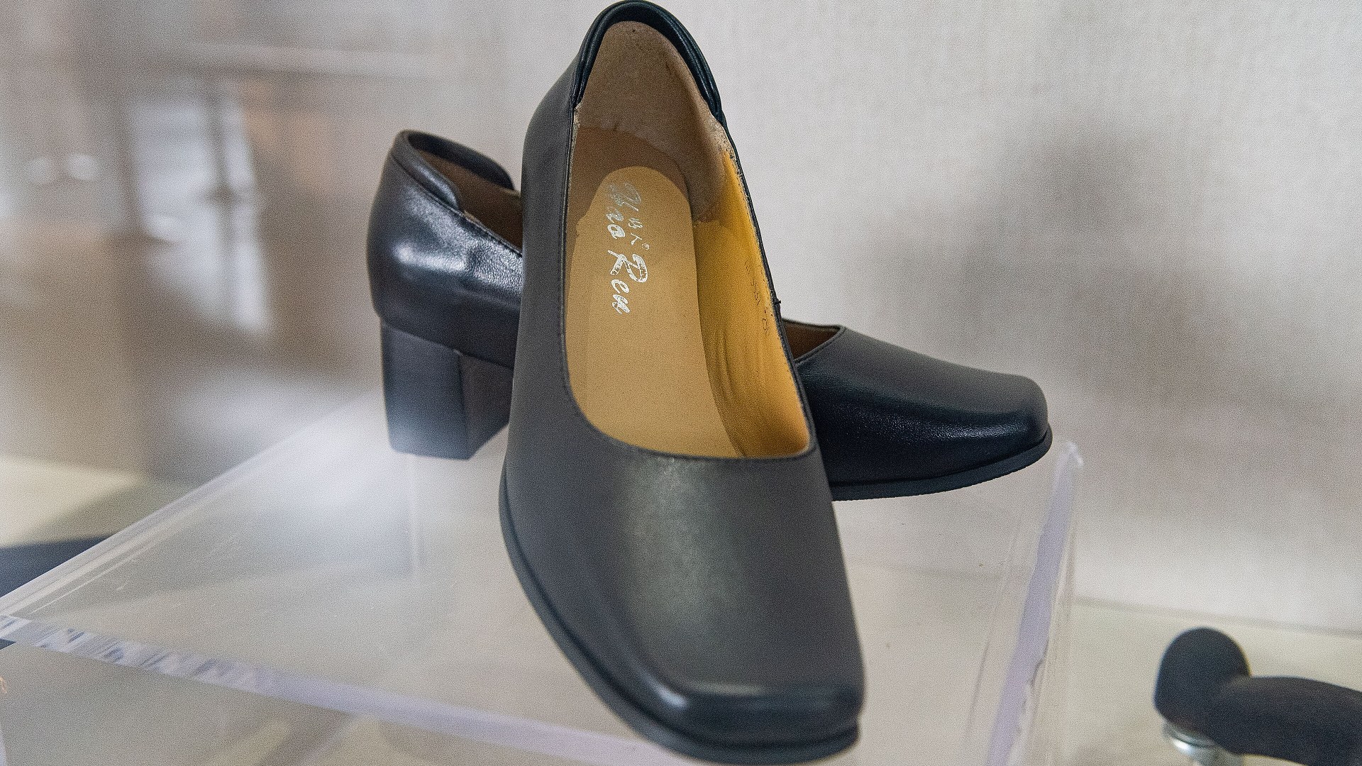 Pair of black high-heeled shoes without arch support