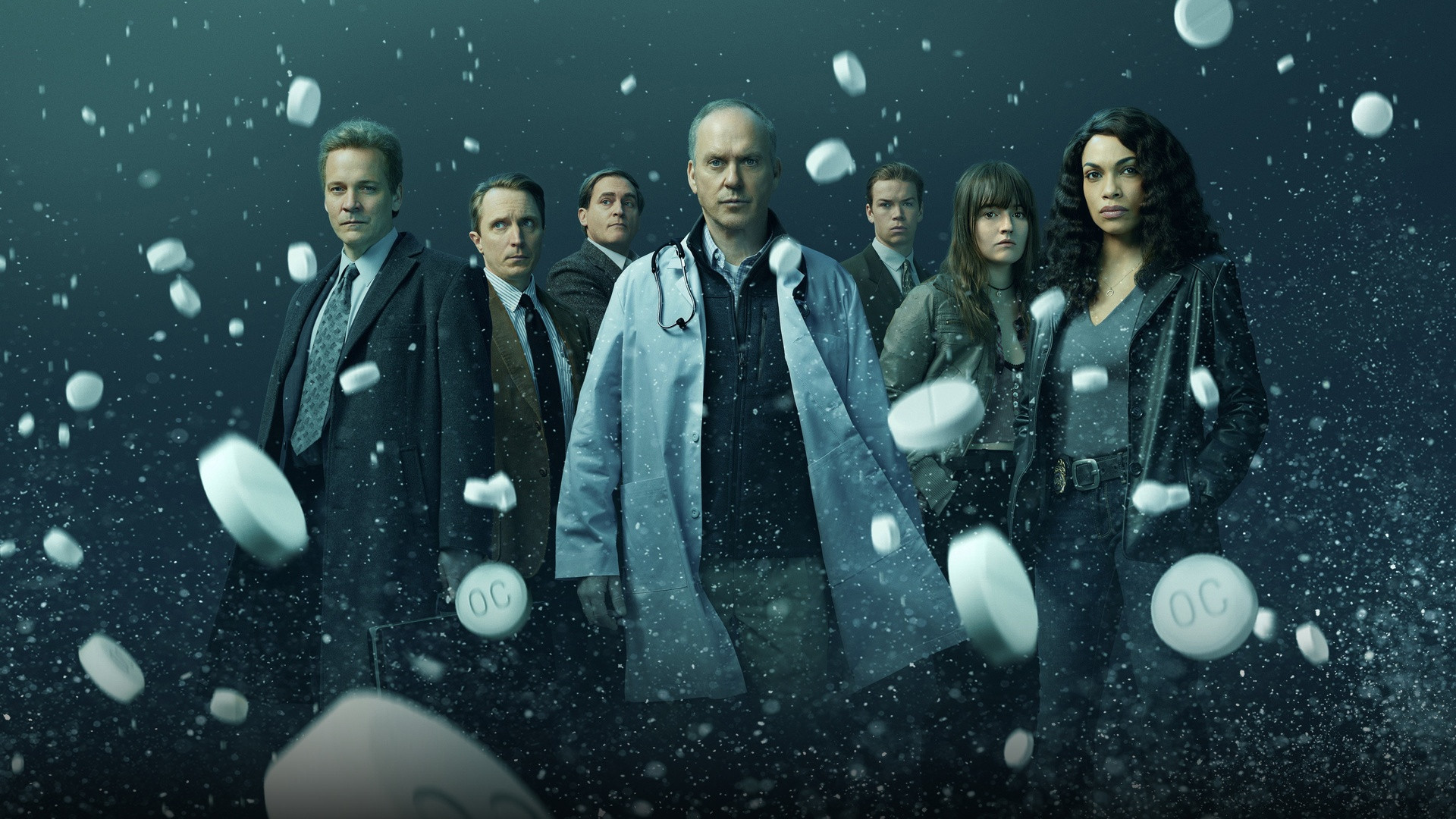 Michael Keaton as Dr. Samuel Finnix with stethoscope and floating OxyContin pills in Dopesick