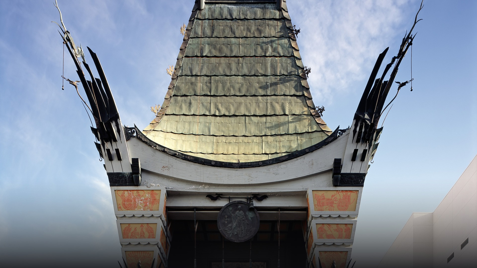 Iconic exterior of Grauman's Chinese Theatre on Hollywood Boulevard featuring ornate Asian pagoda architecture.