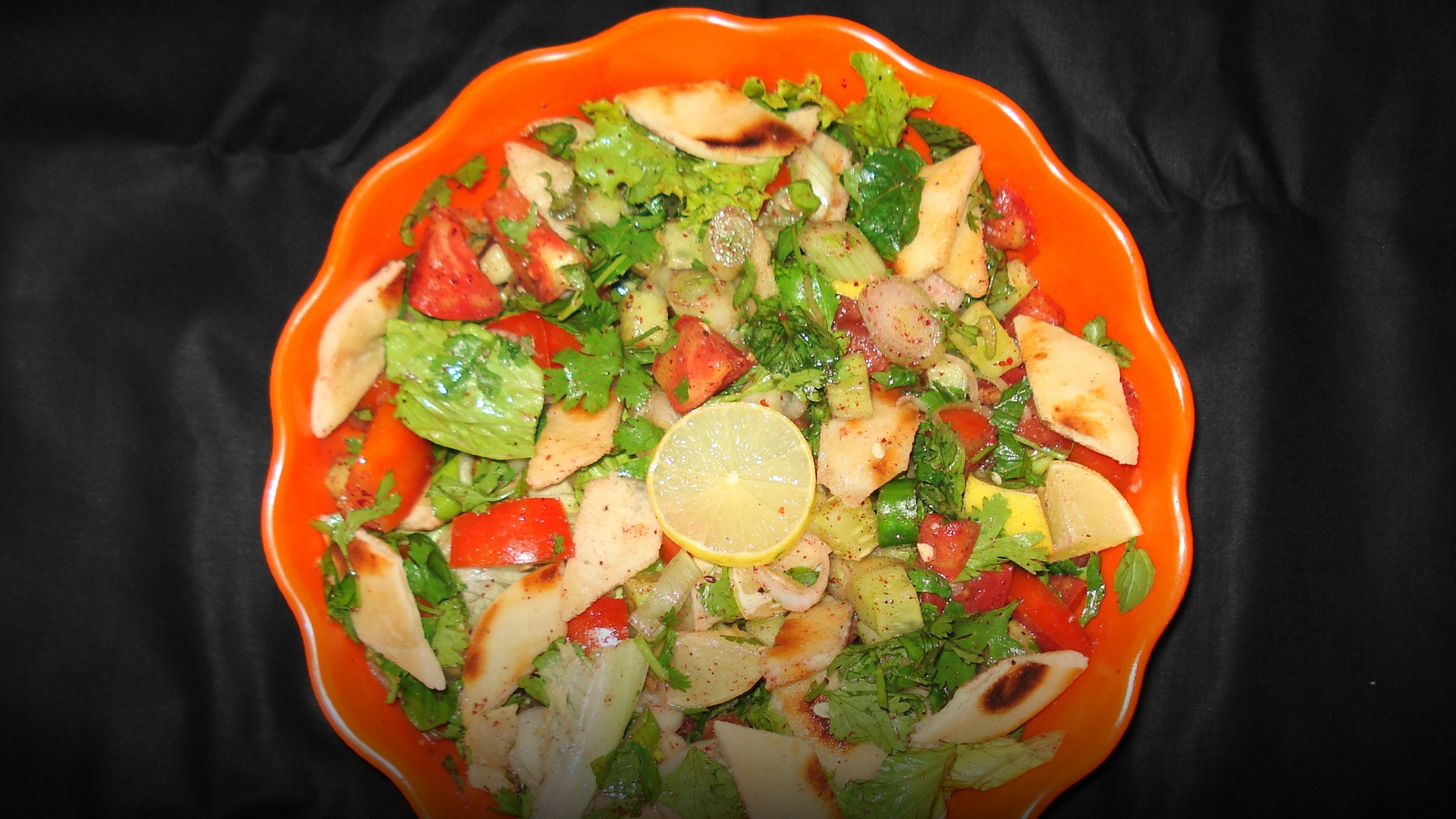 A colorful bowl of fresh Levantine Fattoush salad featuring crisp cucumbers, radishes, tomatoes, and golden pita crisps.