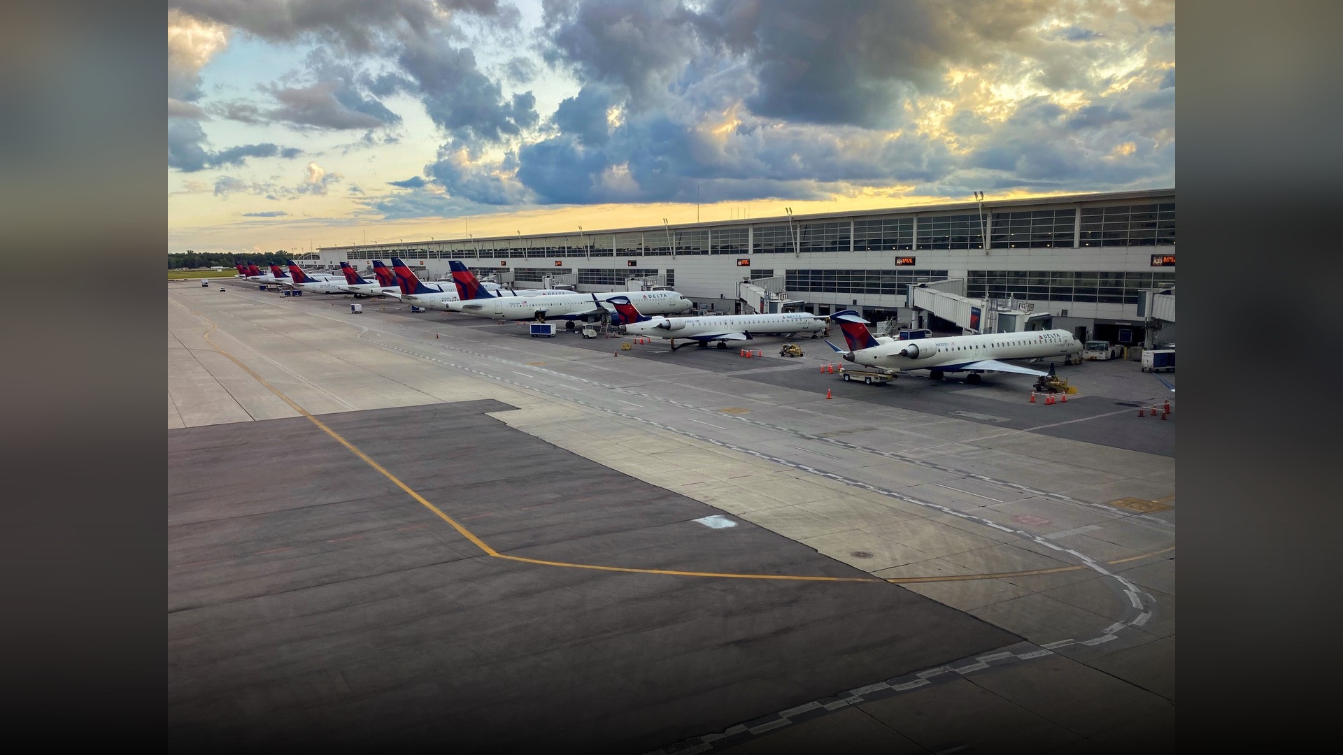 The expansive interior of the McNamara Terminal at Detroit Metropolitan Airport with the red ExpressTram overhead.