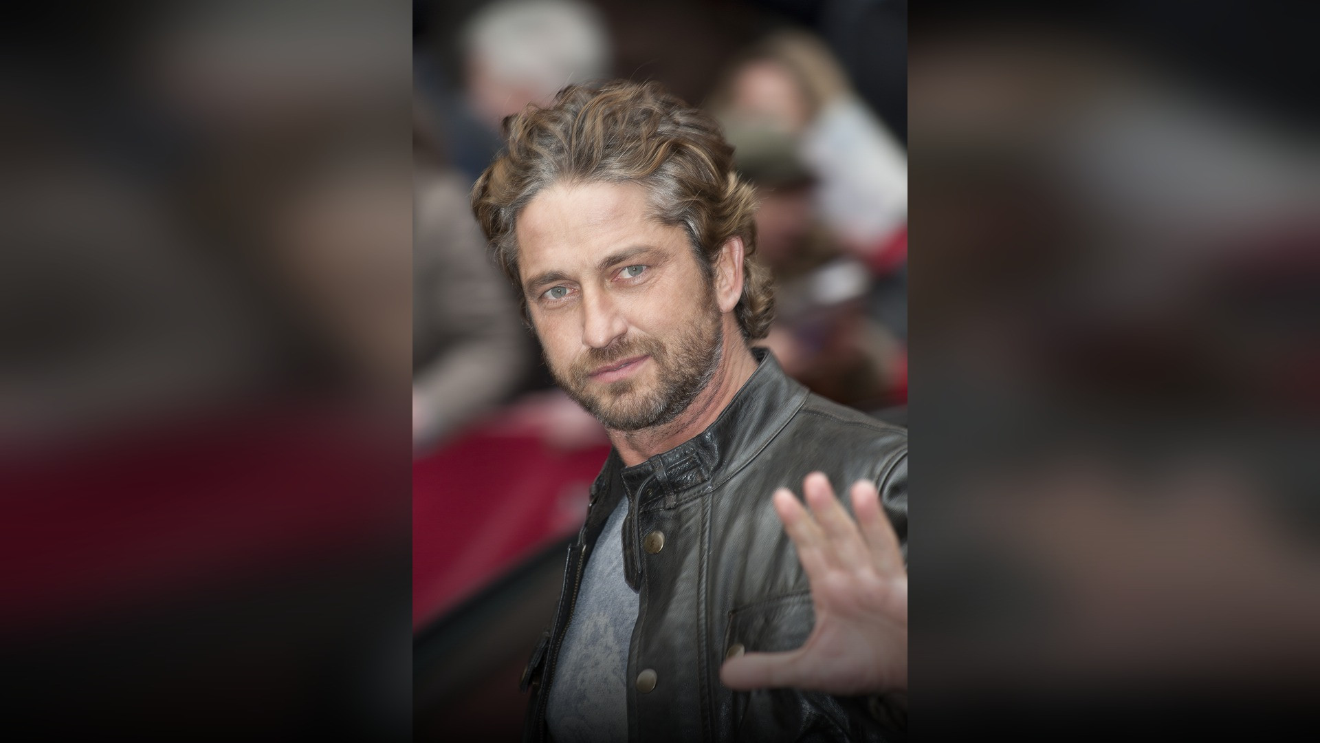 High-resolution portrait photograph of Gerard Butler celebrating academic achievement.