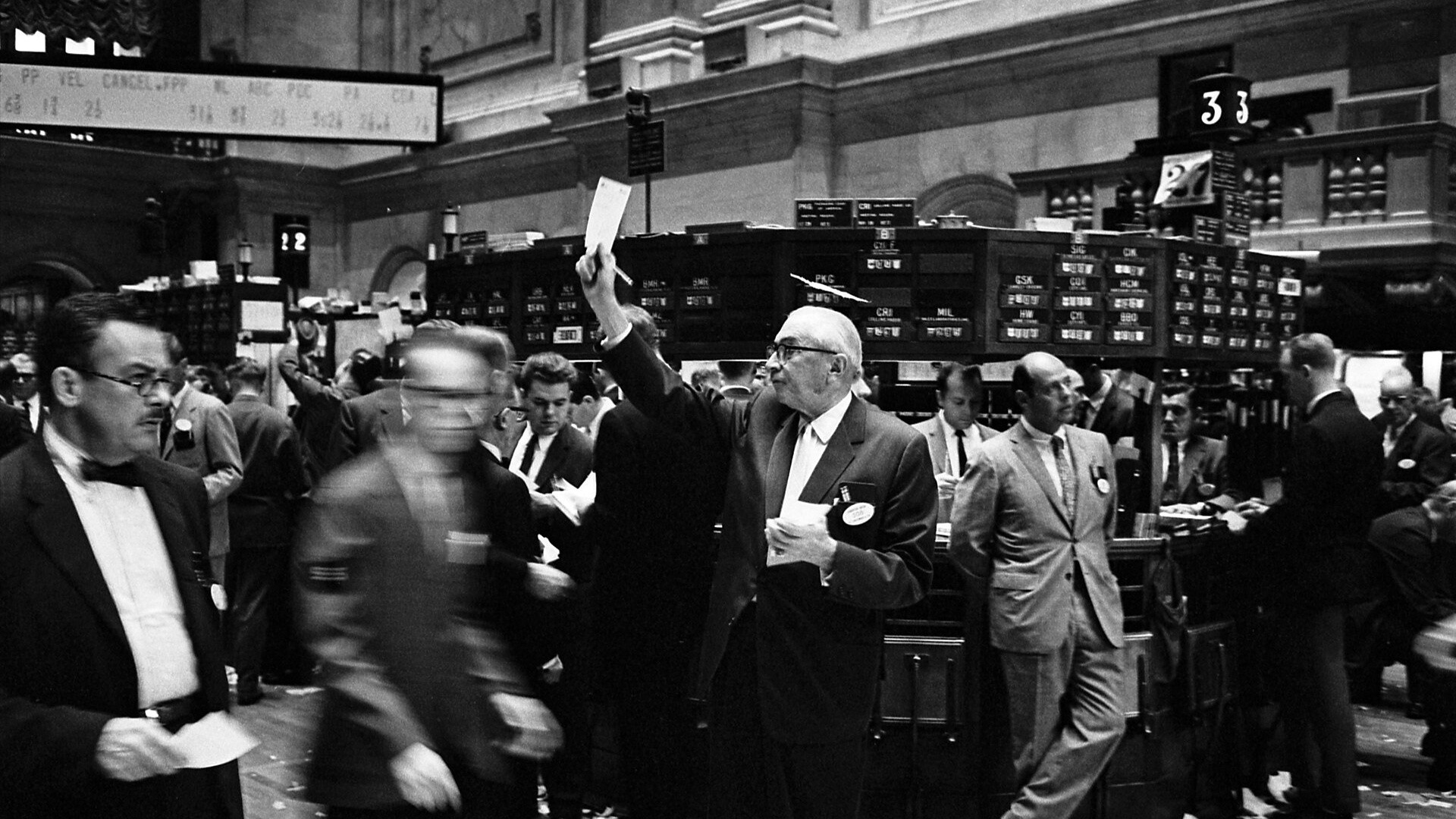New York Stock Exchange trading floor showing trading specialists and electronic screens.