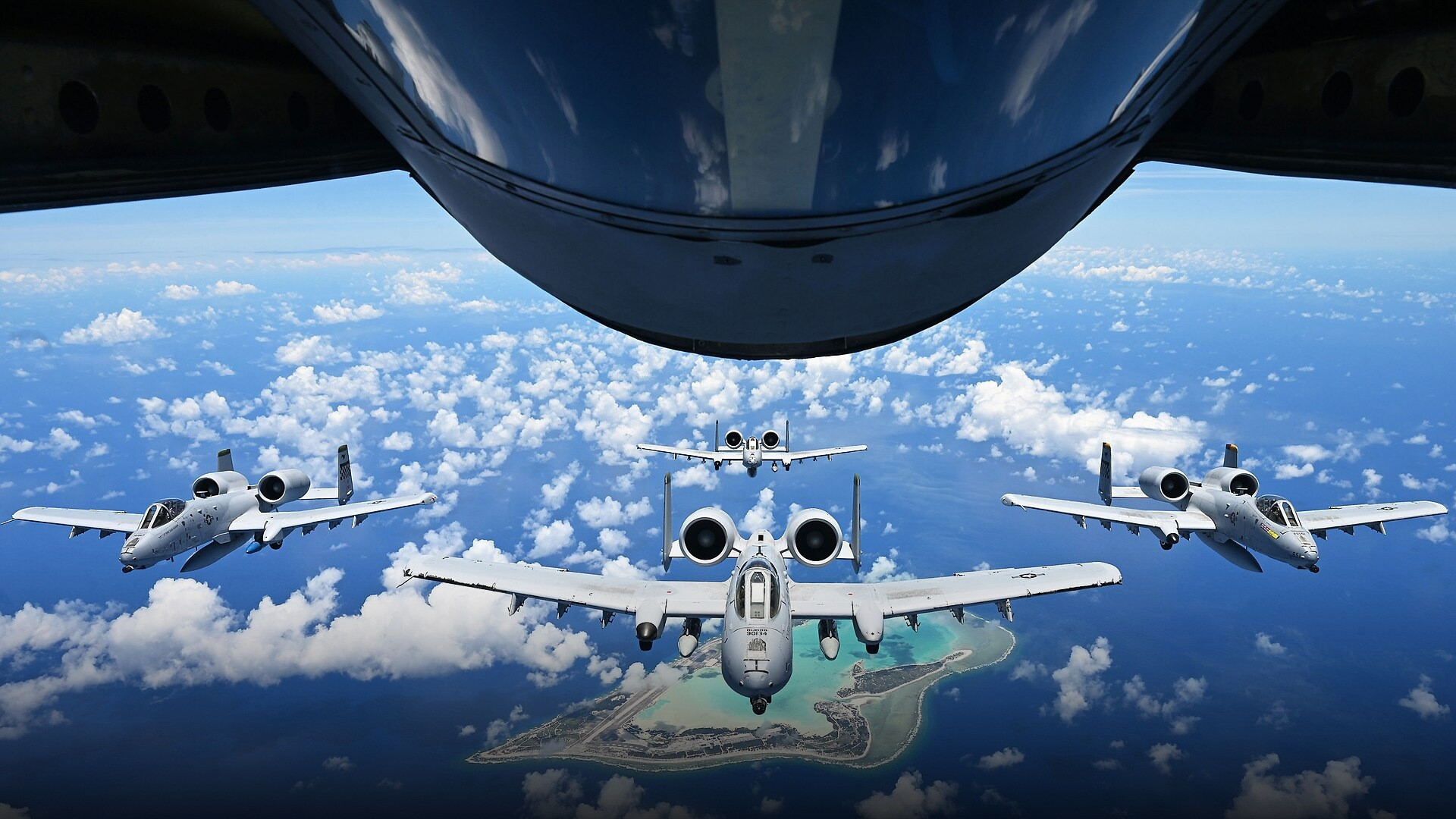 Pair of U.S. Air Force A-10C Thunderbolt II aircraft in low-altitude formation flight.