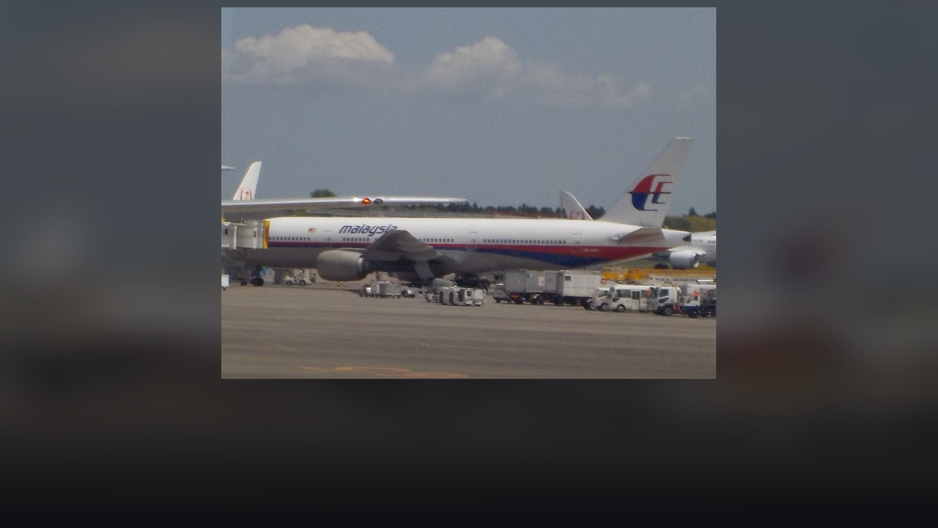 Malaysia Airlines Boeing 777-200ER wide-body twin-jet aircraft in red and blue stripe livery.