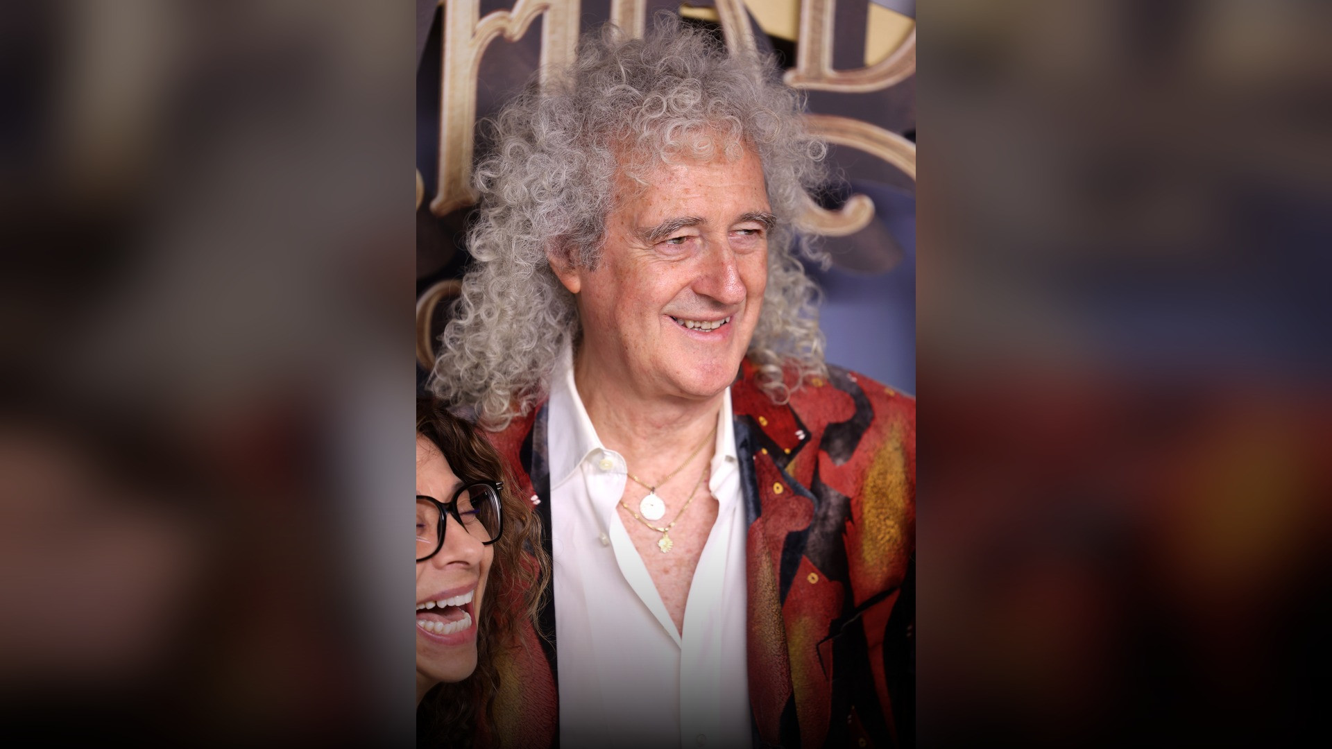 High-resolution portrait photograph of Brian May celebrating academic achievement.