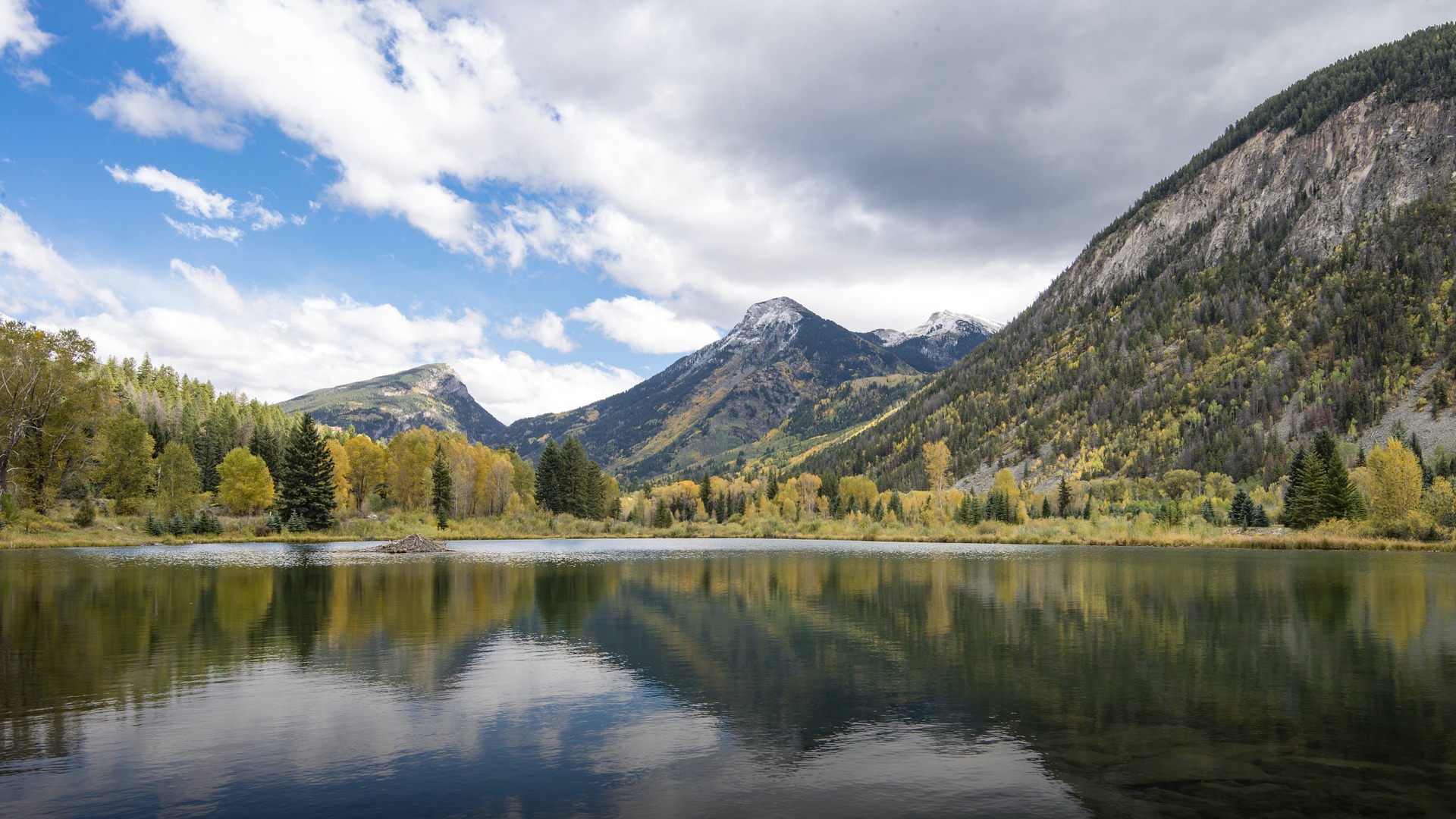 The iconic snow-covered Maroon Bells peaks near Aspen Colorado towering over a frozen alpine valley.