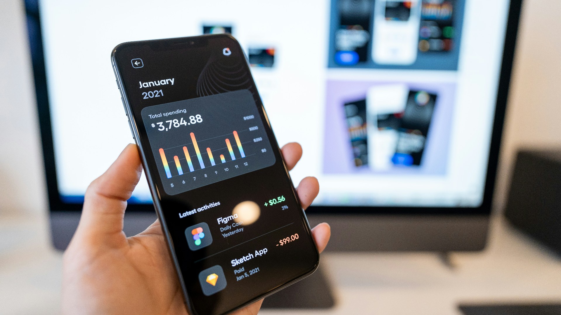 Person holding a smartphone with mobile app icons displayed on screen