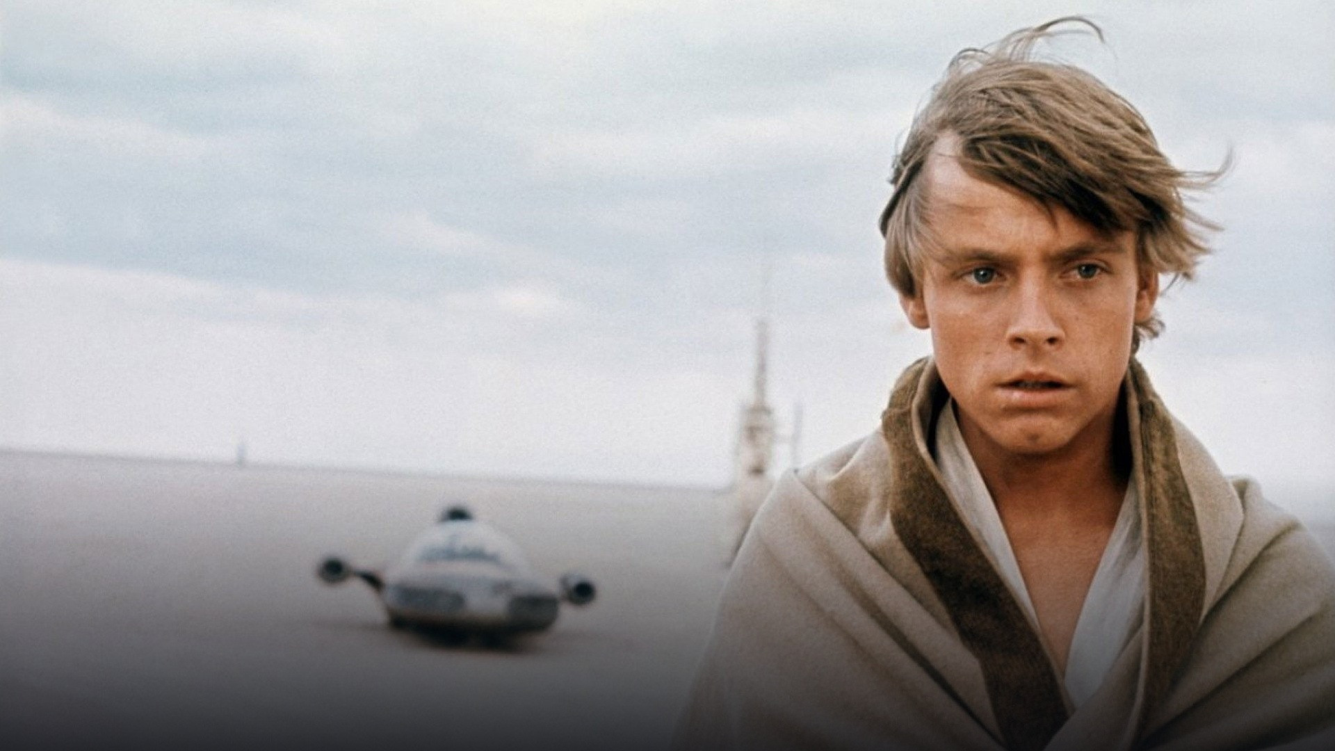 Luke Skywalker gazing out at the twin suns of Tatooine in Star Wars.
