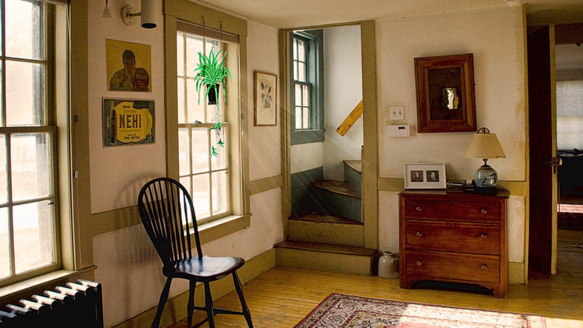 Sunlit hallway with framed art on the wall