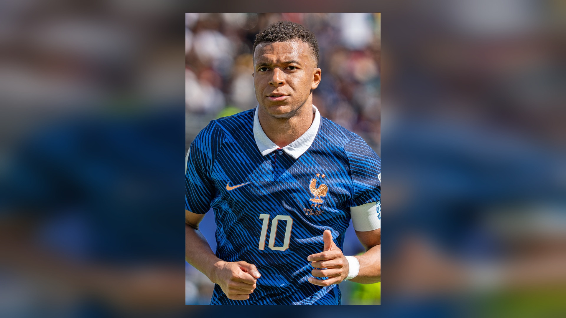Close-up photograph of Kylian Mbappé in blue international kit.
