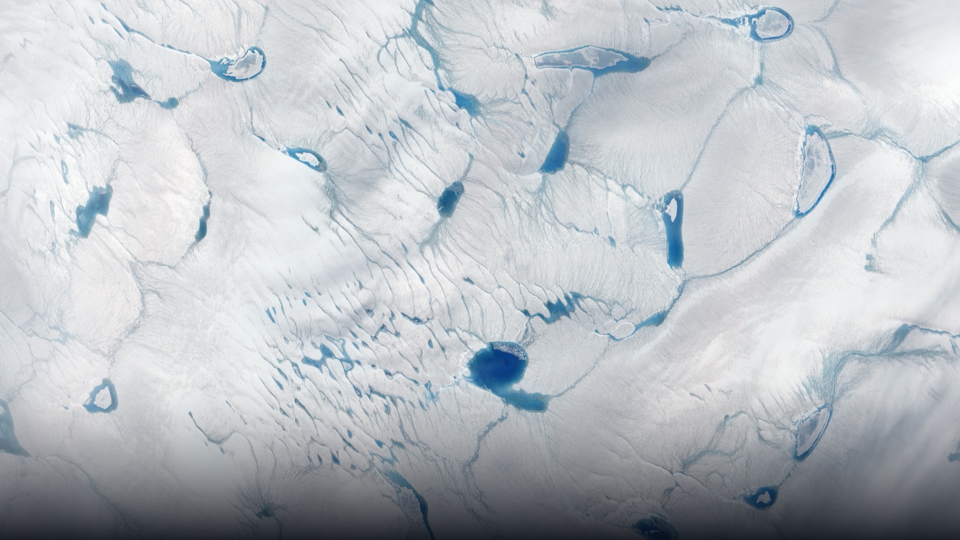 NASA satellite view of glacial meltwater river on the Greenland Ice Sheet.