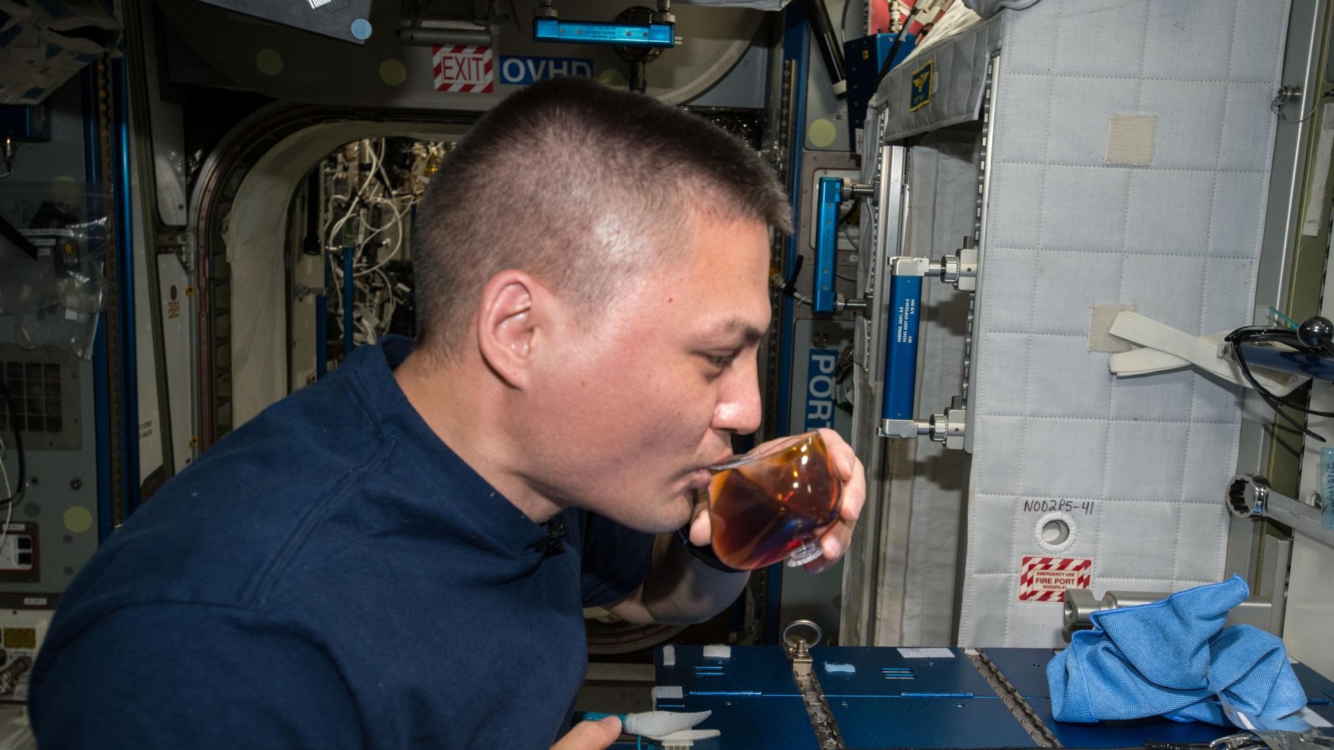 Astronaut Kjell Lindgren drinking espresso from the specially designed Capillary Beverage Cup aboard the ISS