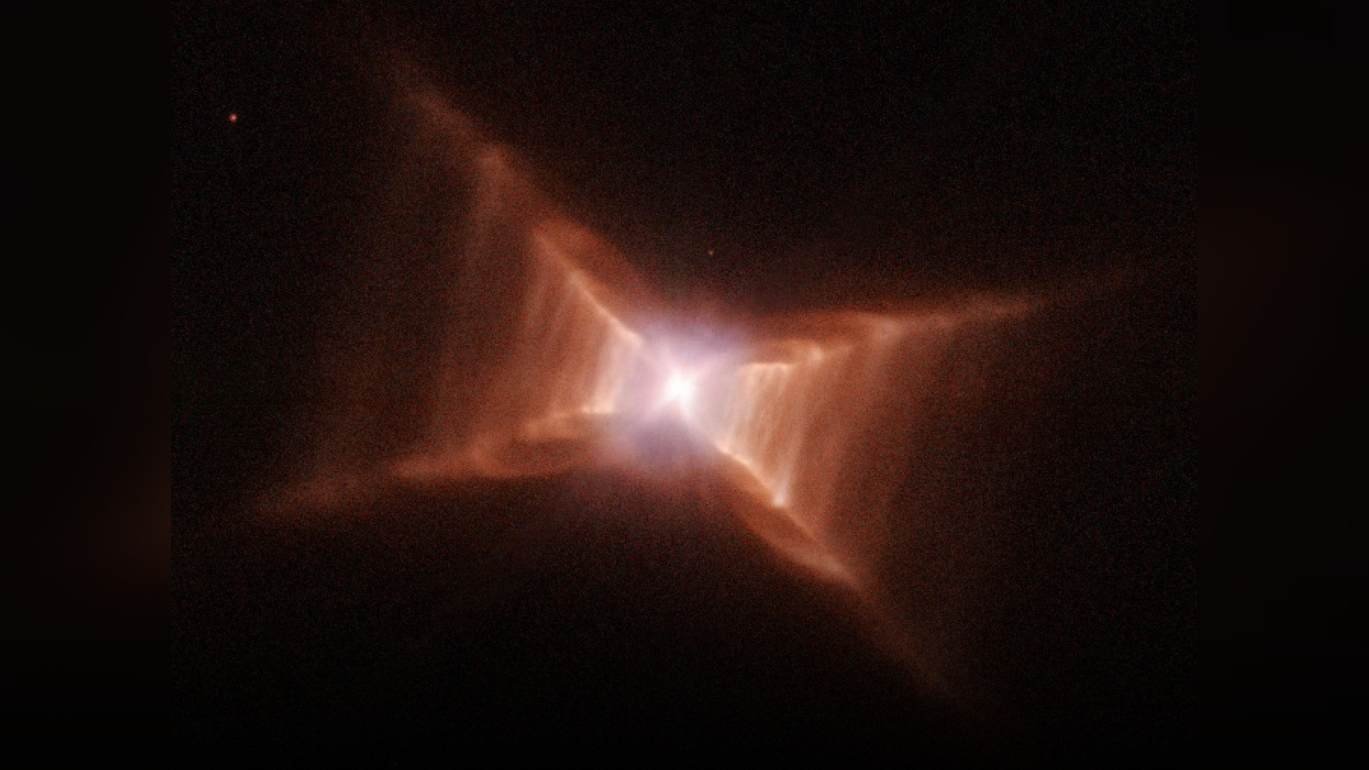 An authentic Hubble Space Telescope photograph of the Red Rectangle Nebula displaying its glowing X-shaped ladder structure.