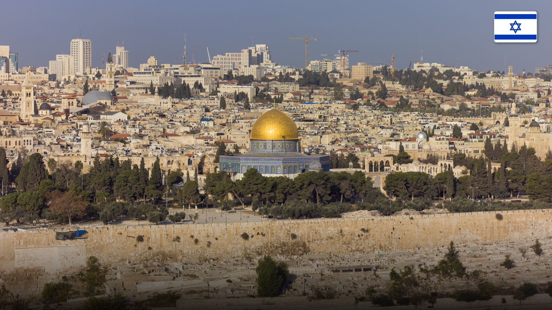 Panoramic view of the Old City of Jerusalem with the Dome of the Rock and ancient ramparts.