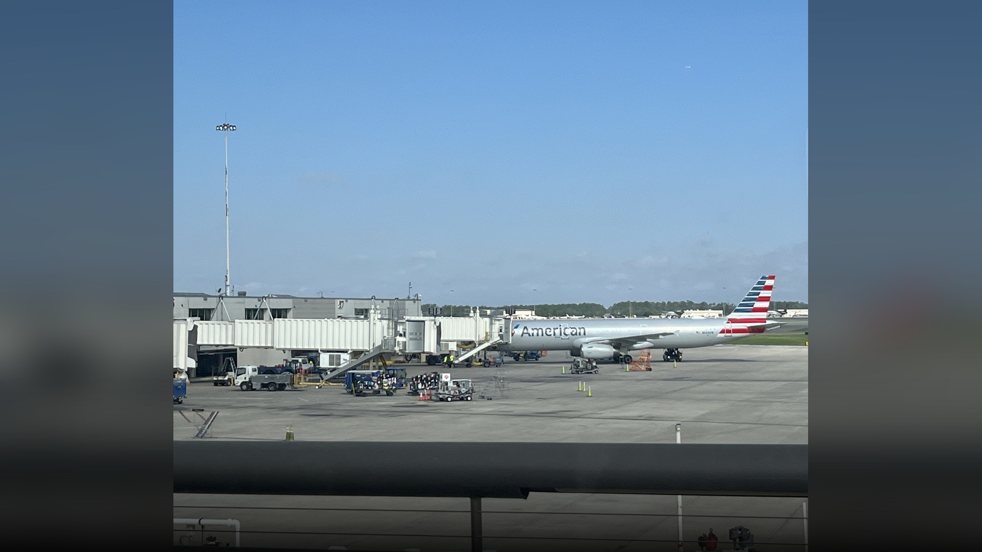 Commercial passenger aircraft parked at the terminal jet bridges at Orlando International Airport under sunny skies.