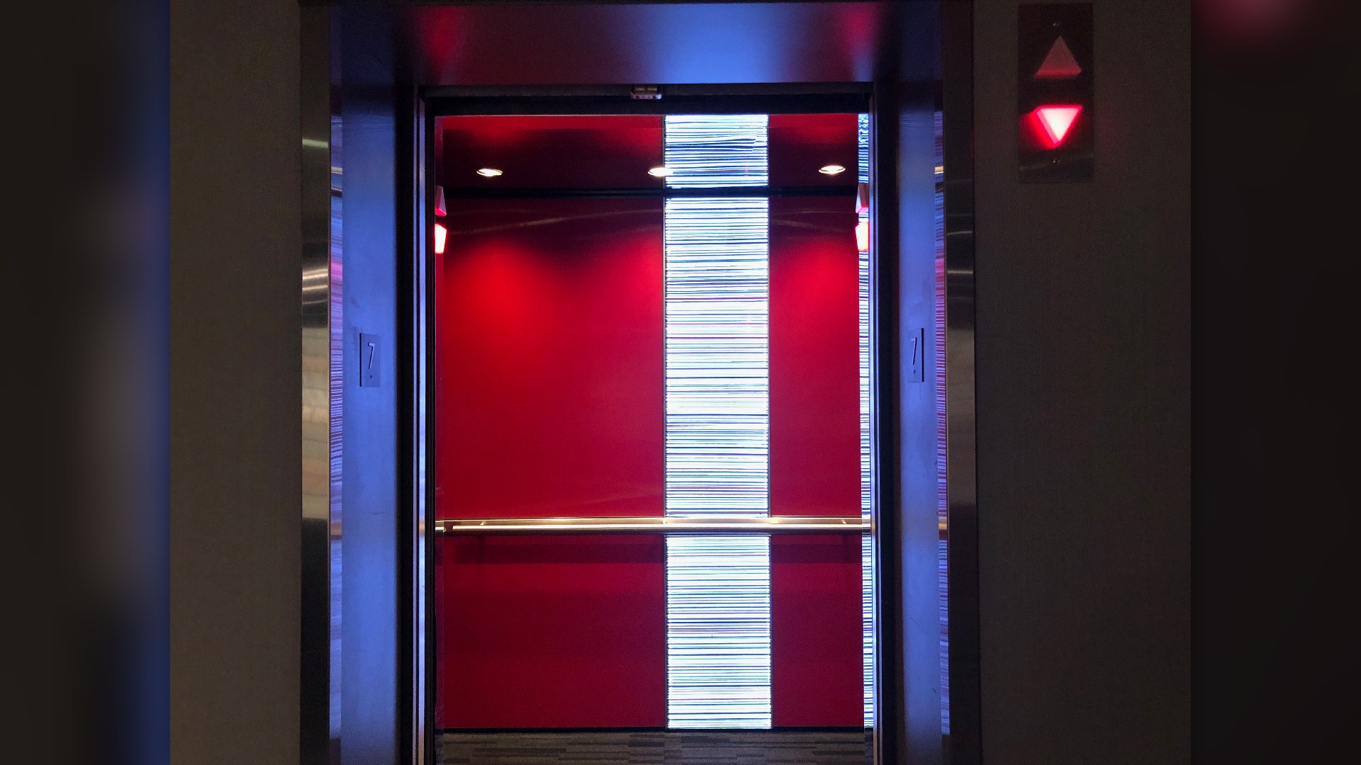 Hotel elevator doors opening into lobby corridor