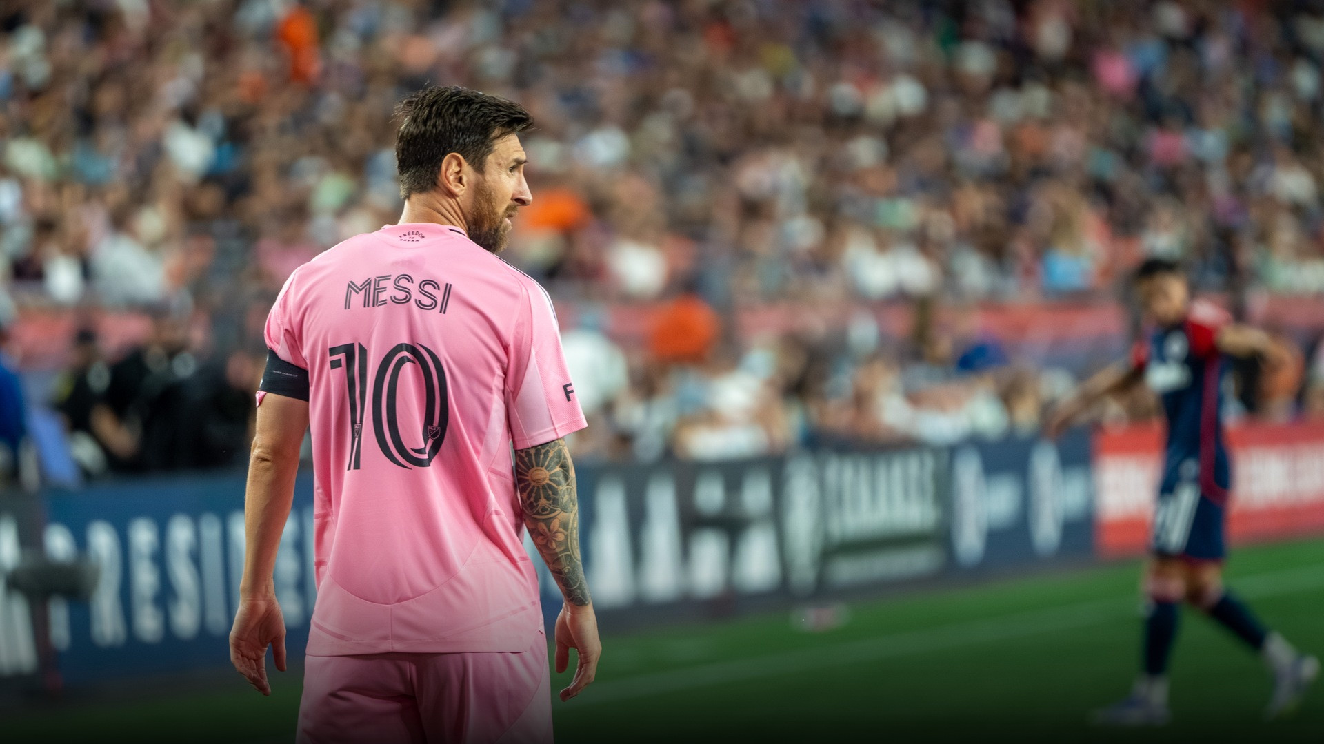 Lionel Messi in full flight demonstrating exceptional physical fitness during a competitive match.