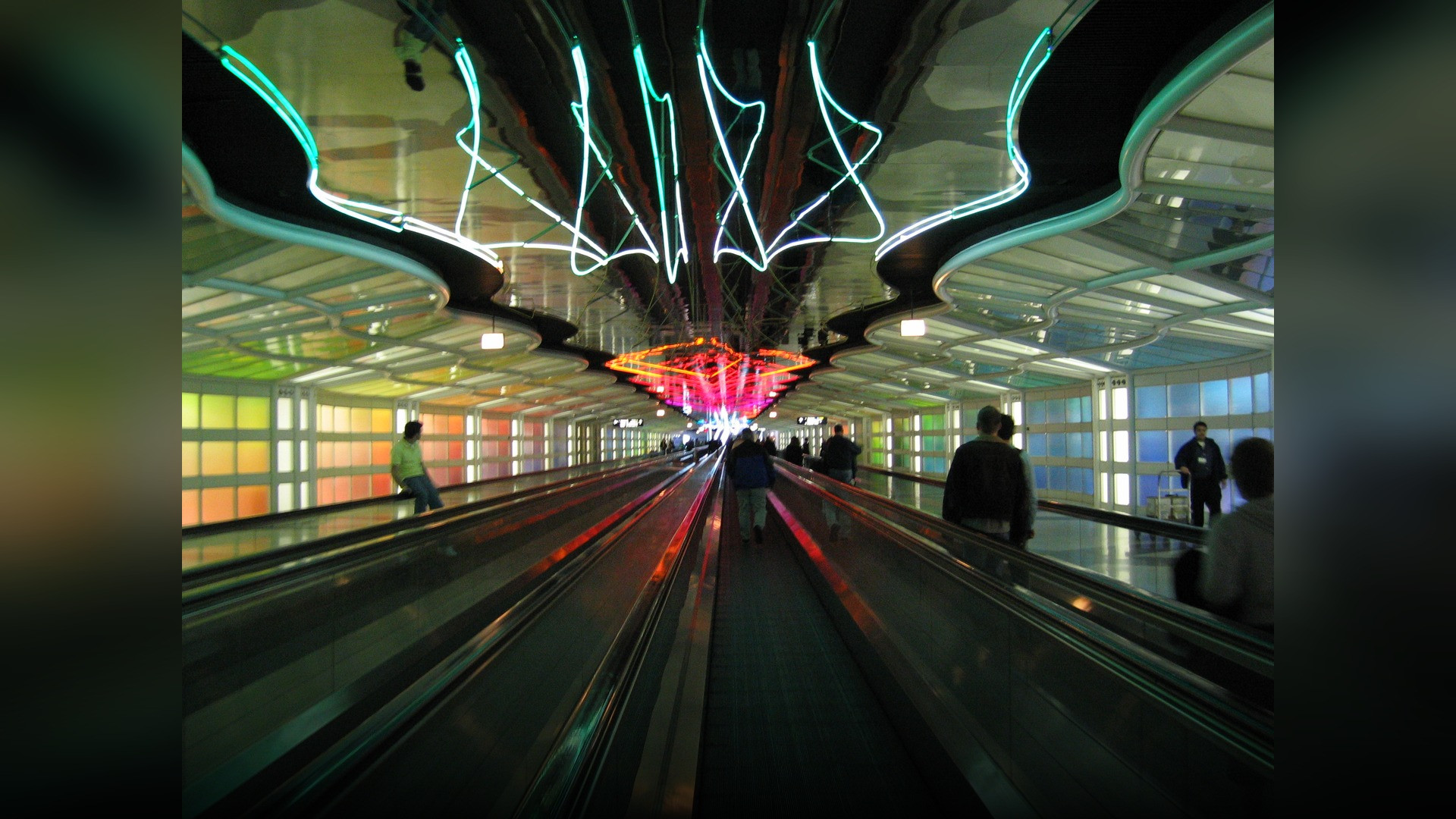 The iconic neon light tunnel connecting concourses B and C inside Terminal 1 at Chicago O'Hare International Airport.