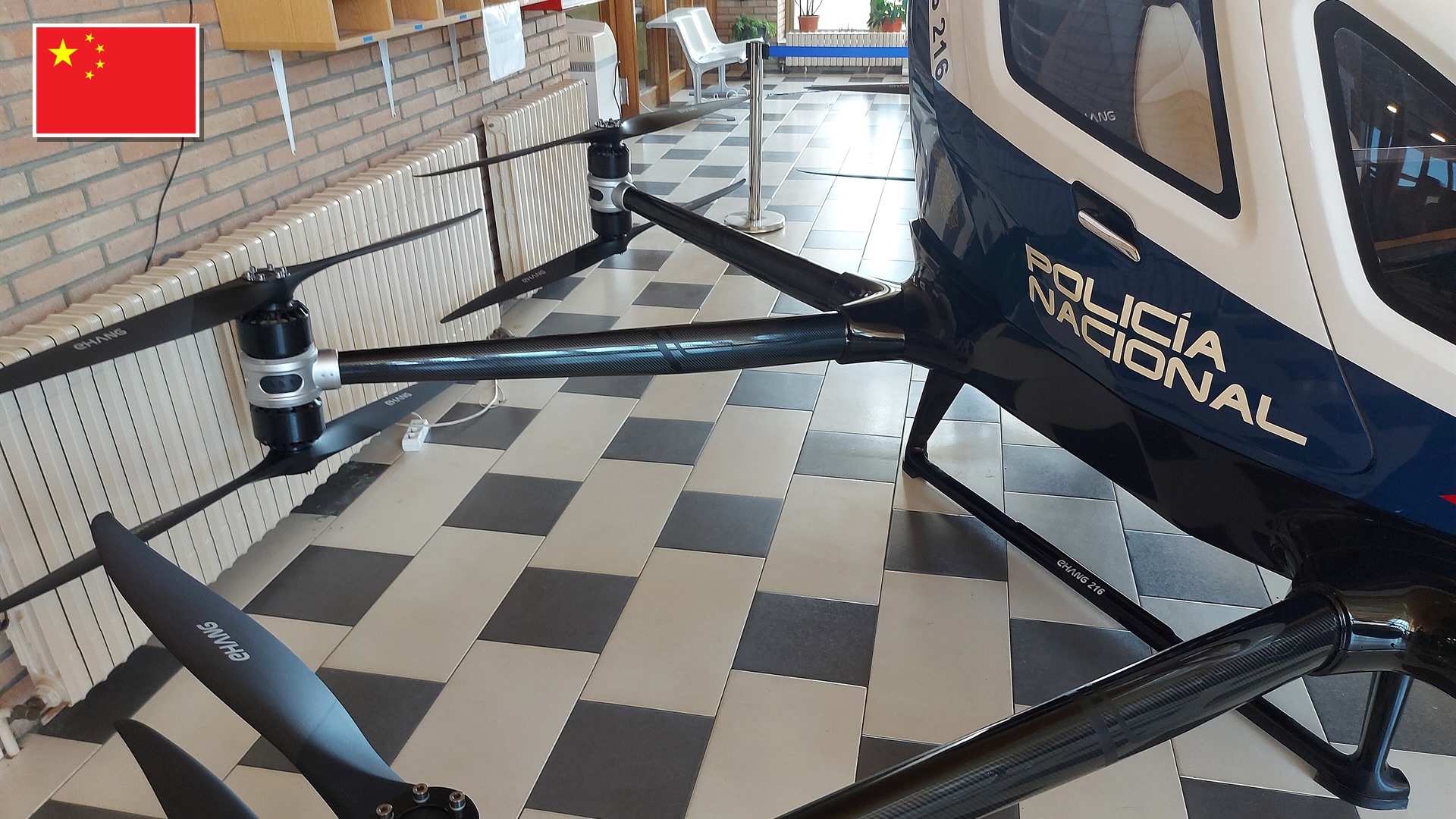 EHang EH216-S autonomous 2-passenger electric multicopter with the flag of China in the top-left corner.