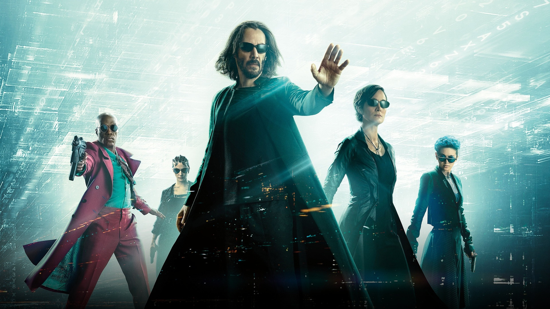 Neo raising his hand to halt incoming bullets with Trinity and allies in The Matrix Resurrections.