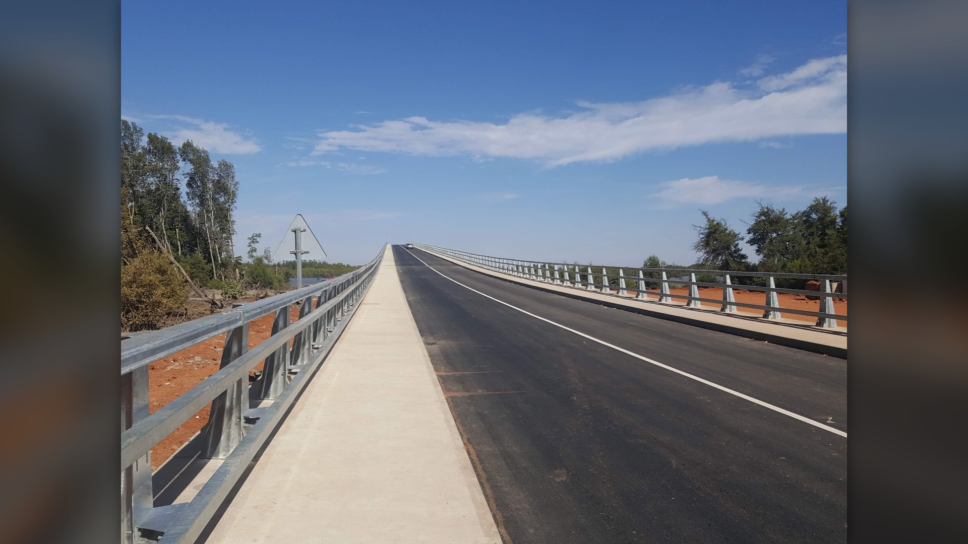 Landscape view of the Senegambia Bridge spanning the Gambia River where The Gambia is surrounded by Senegal.