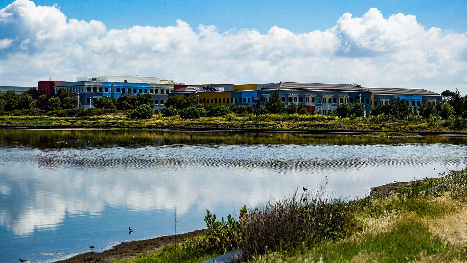Mark Zuckerberg portrait and the 1 Hacker Way headquarters campus in Menlo Park, California.