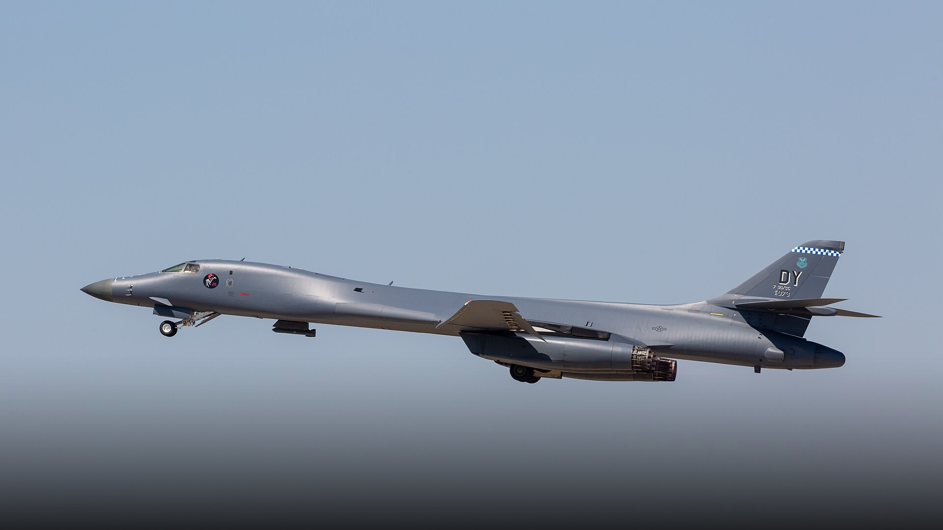 Rockwell B-1B Lancer supersonic strategic bomber soaring with wings swept back.