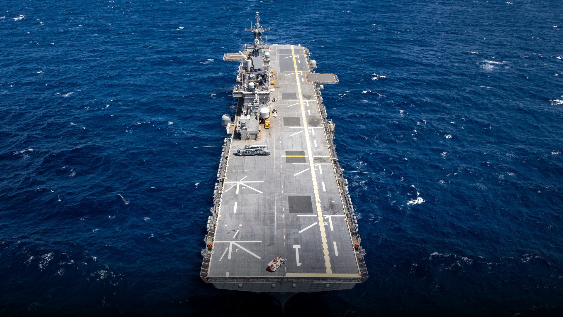 Amphibious assault ship USS Wasp LHD-1 underway transiting the Atlantic Ocean in broad daylight.