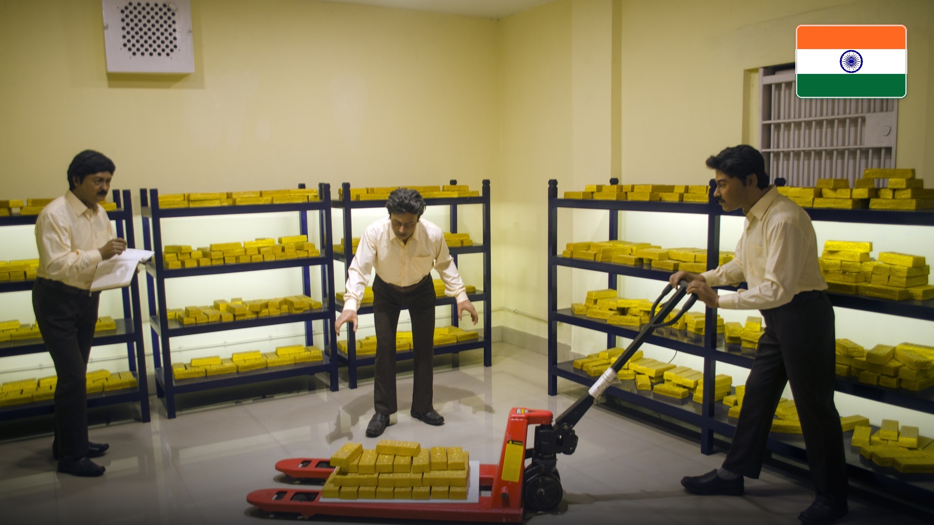 Reserve Bank of India gold vault display showcasing stacked bullion ingots. Official national flag badge in top right.