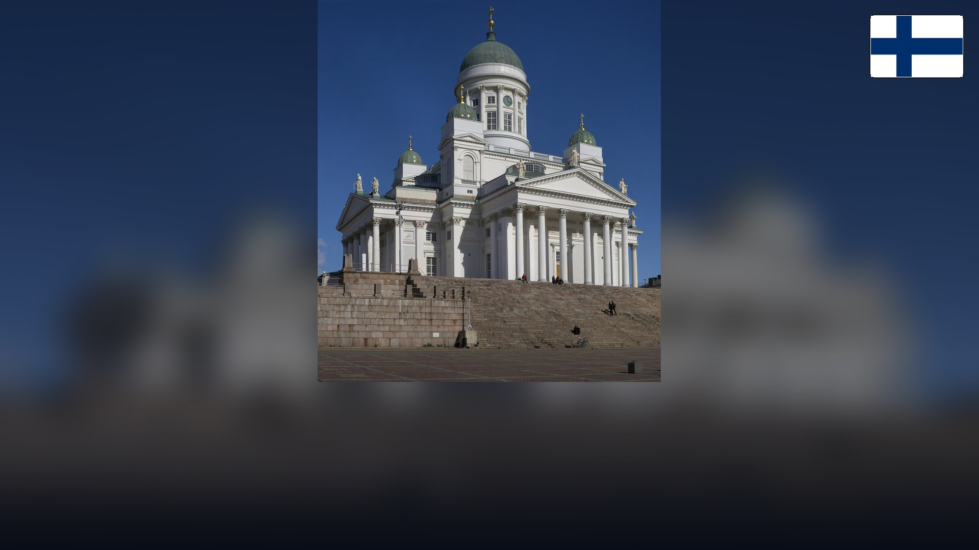 Helsinki Cathedral in Senate Square with the Finnish flag in the top right corner.