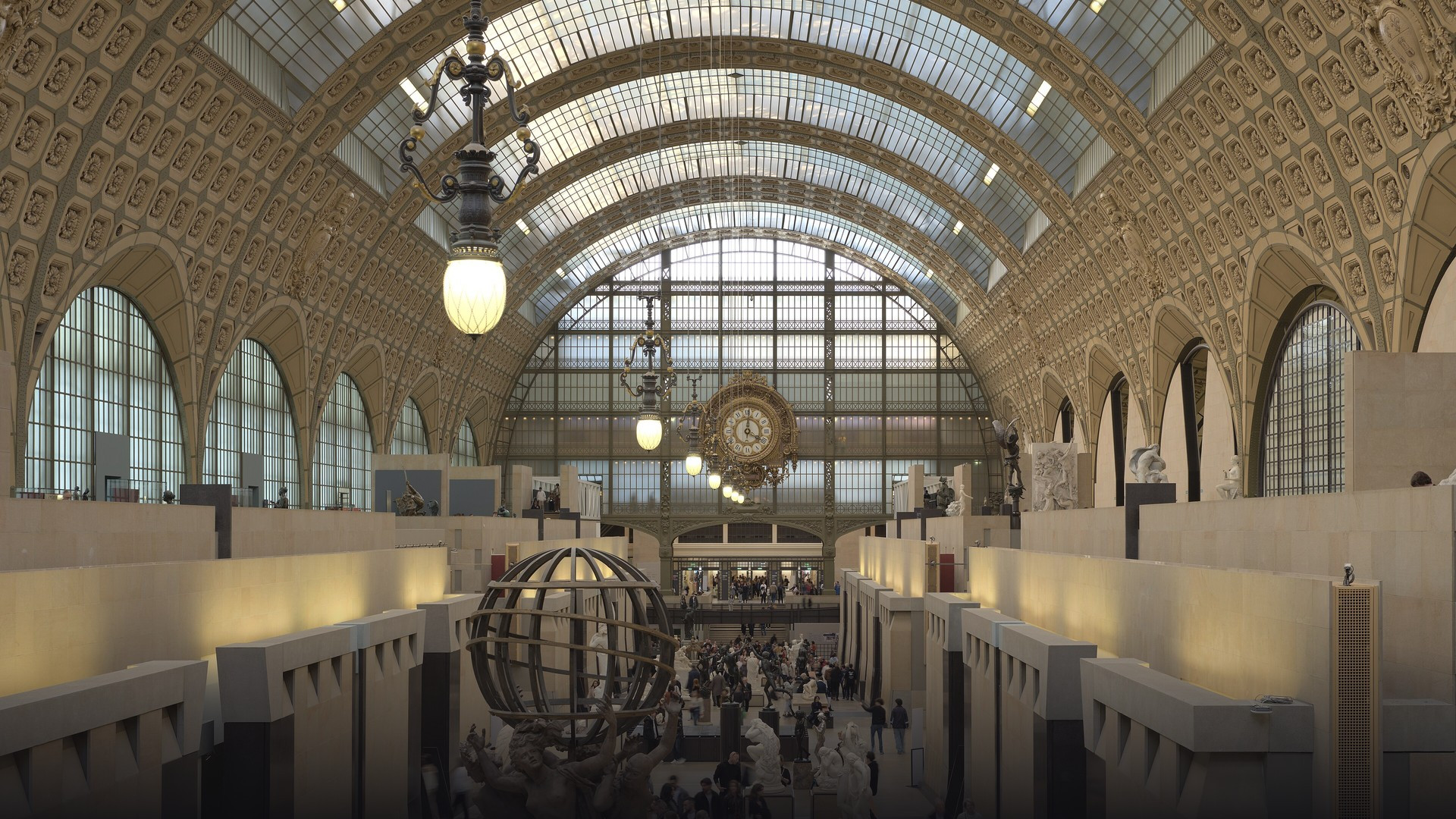 The soaring Beaux-Arts arched ceiling and central sculpture nave inside Musée d'Orsay.