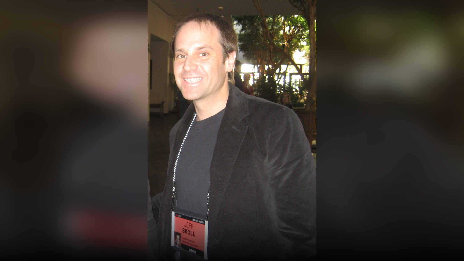 Jeff Skoll smiling during a social impact philanthropic summit.
