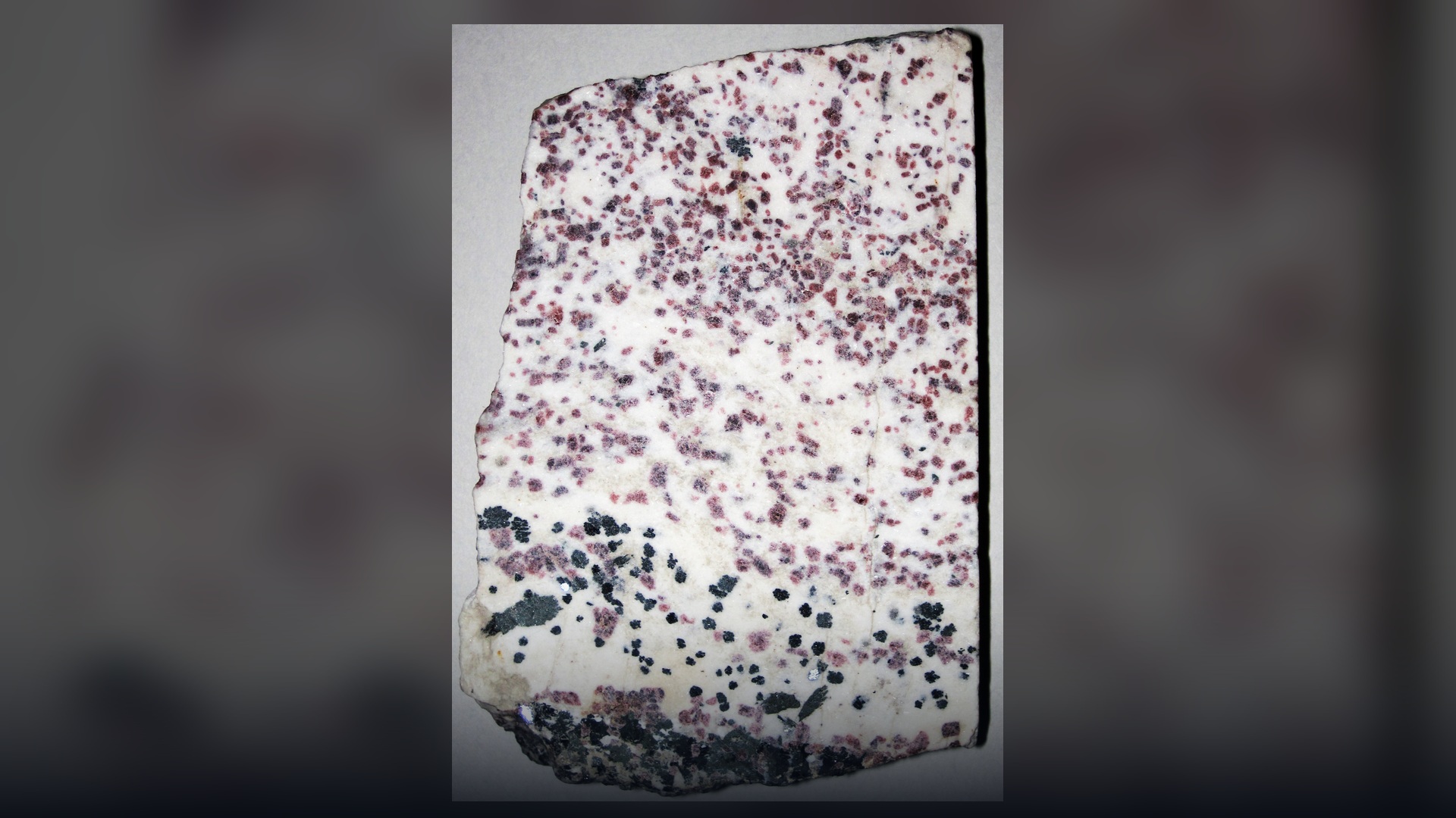 Vivid crimson crystalline eudialyte rare earth mineral in host rock from South Greenland.