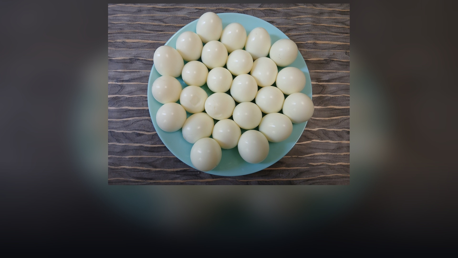 Bright and appetising plate of freshly prepared hard-boiled eggs cut in half displaying vibrant rich yolks.