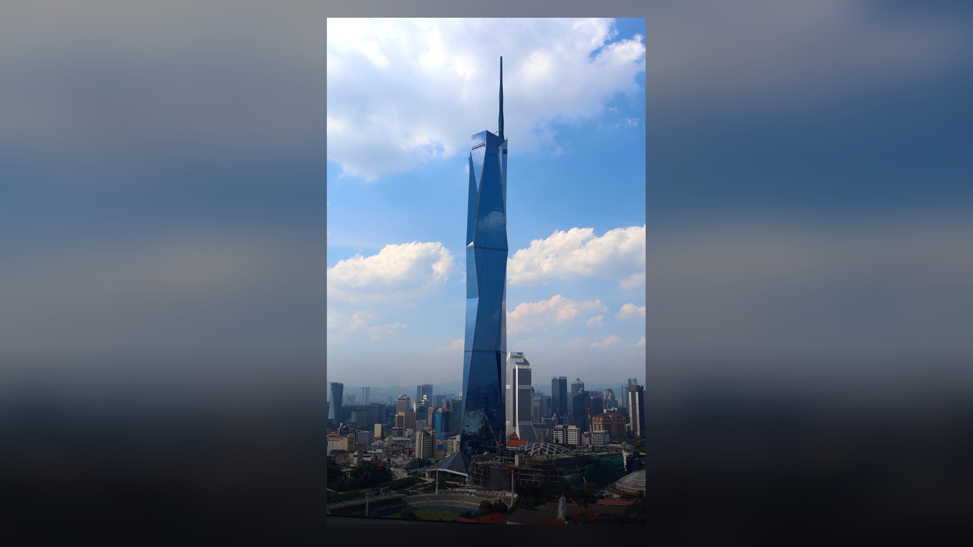 The complete Merdeka 118 megatall tower with its diamond glass facets and soaring spire.