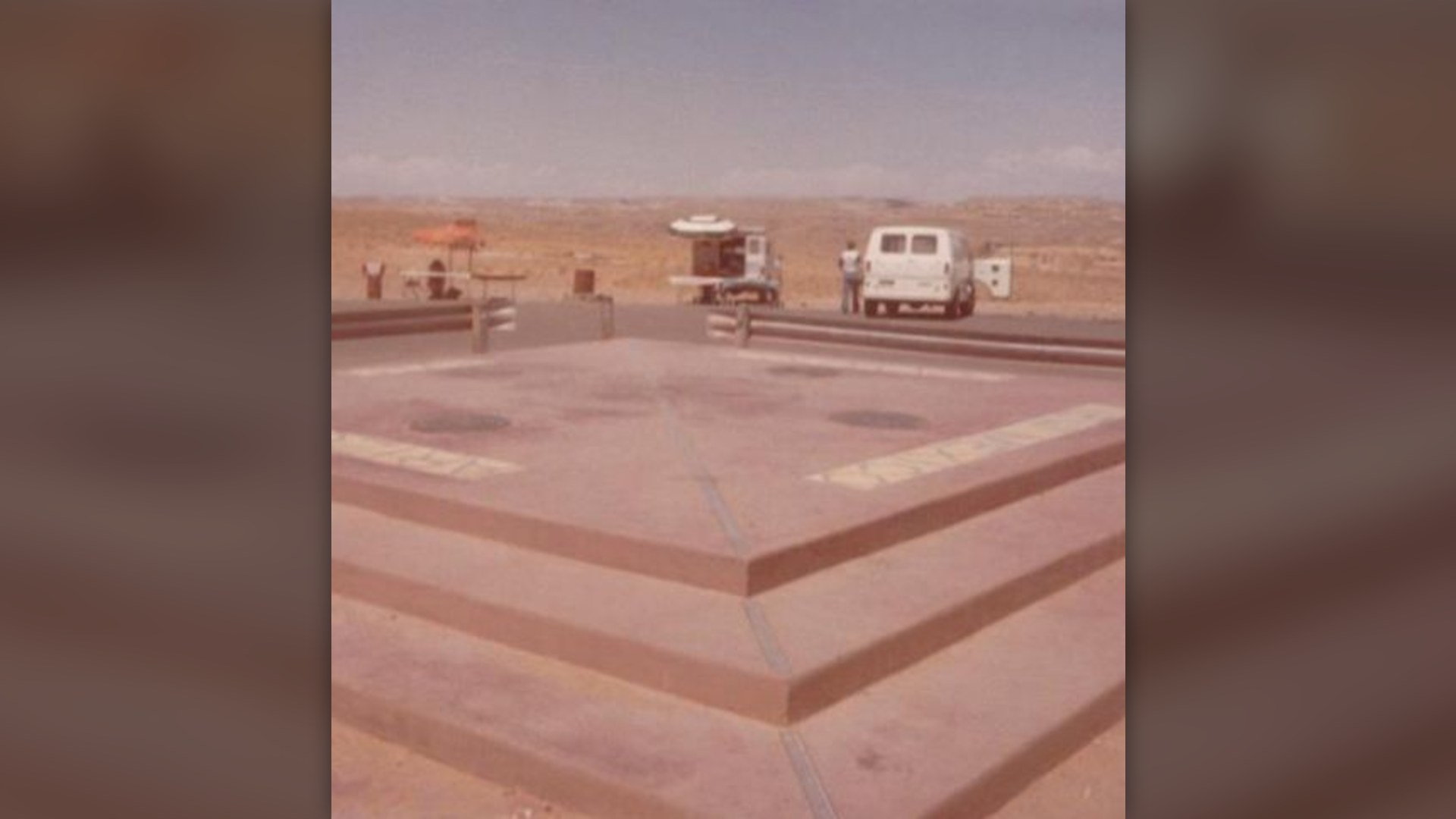 Visitors standing on the brass seal at Four Corners Monument