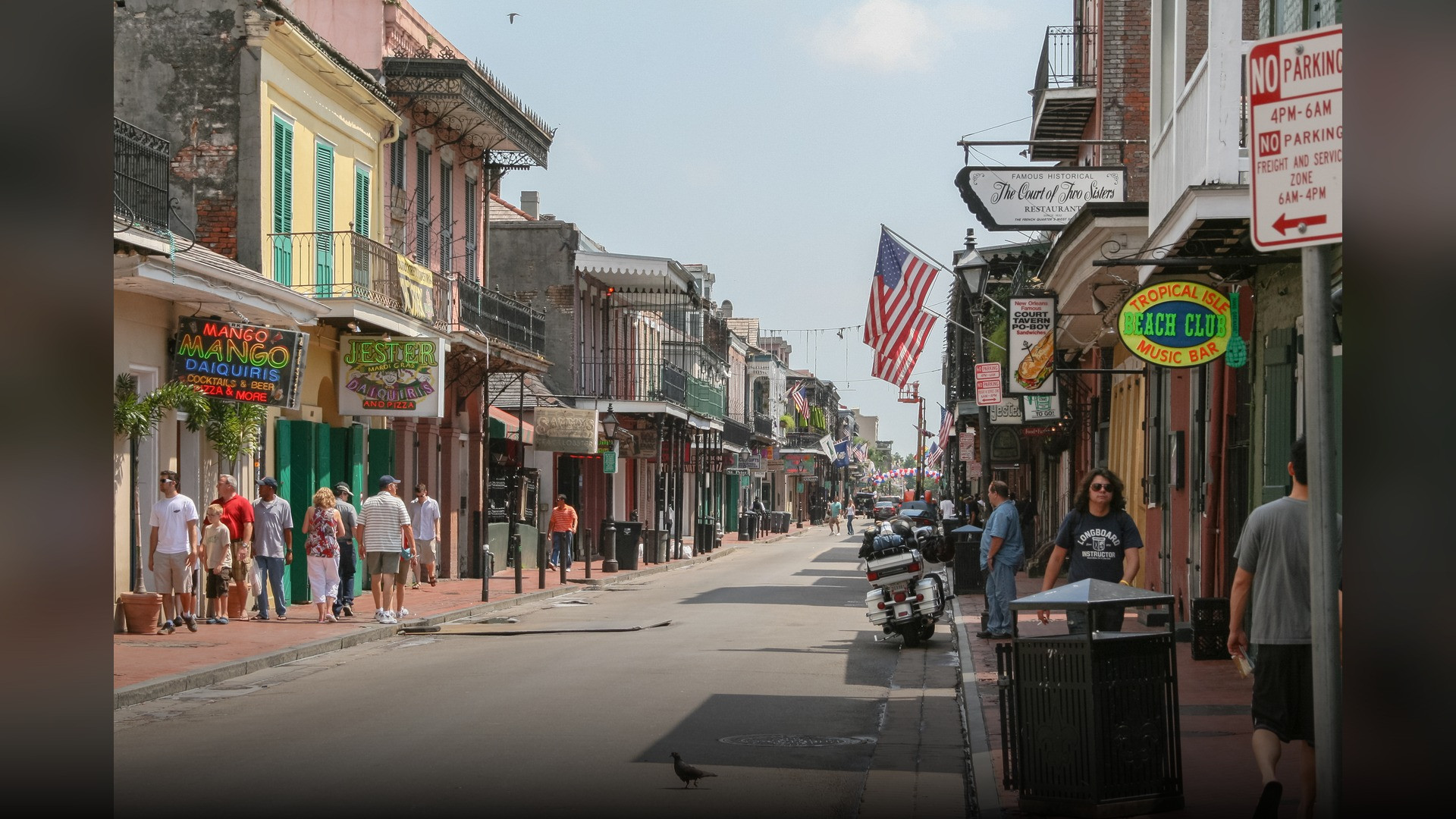 Historic cast-iron balconies on colorful French Quarter buildings in New Orleans Louisiana.