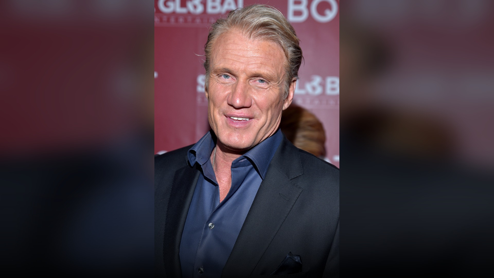 High-resolution portrait photograph of Dolph Lundgren celebrating academic achievement.