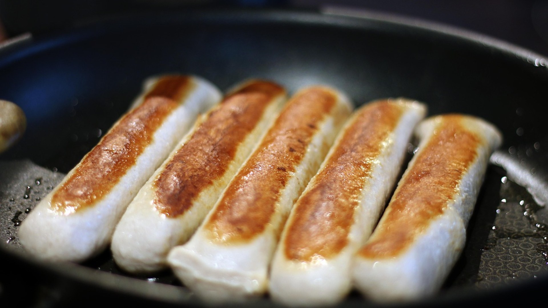 Sausages pan-frying at high heat