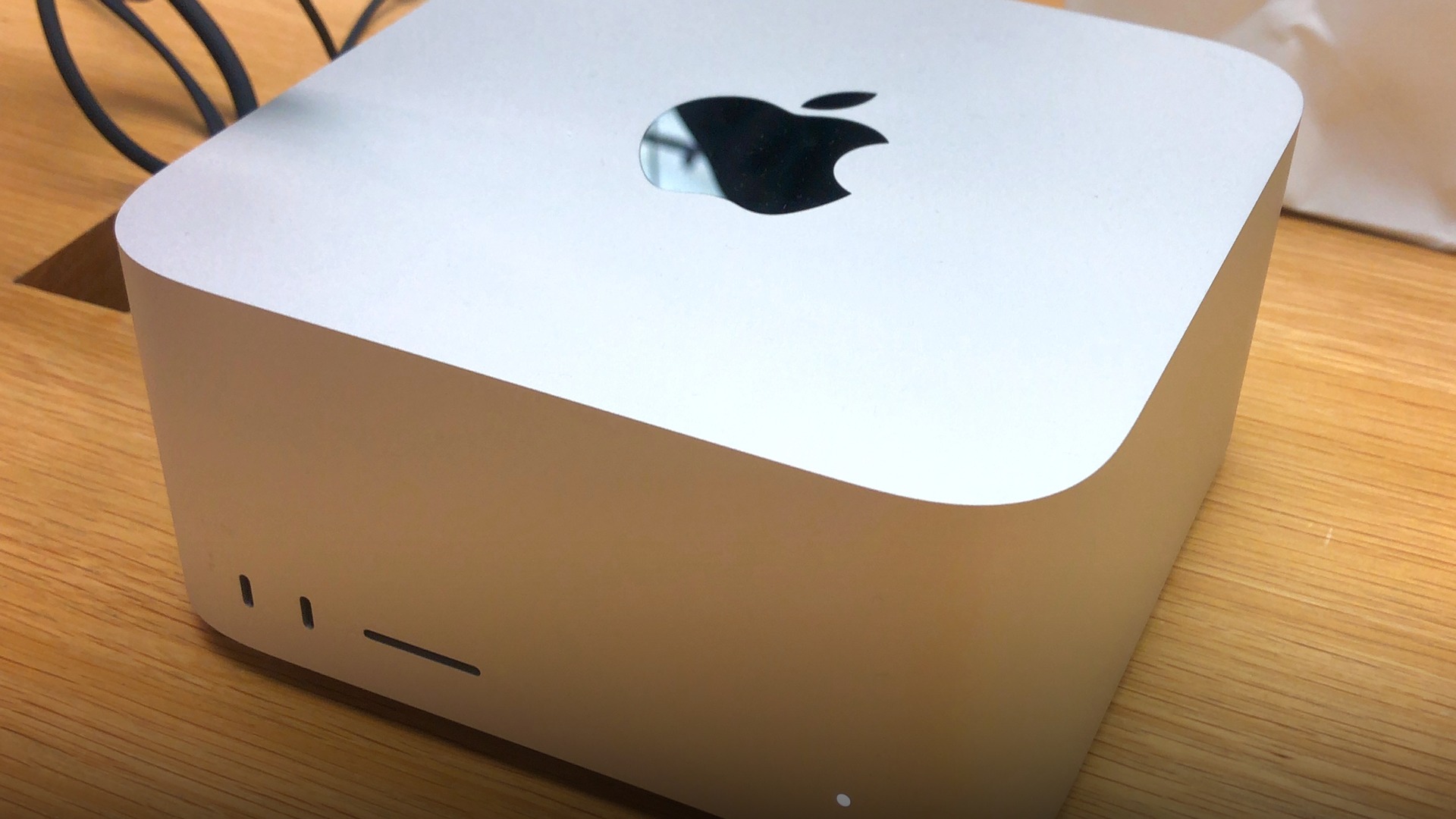Front angled view of silver Apple Mac Studio desktop computer highlighting front SD card slot and Thunderbolt ports.