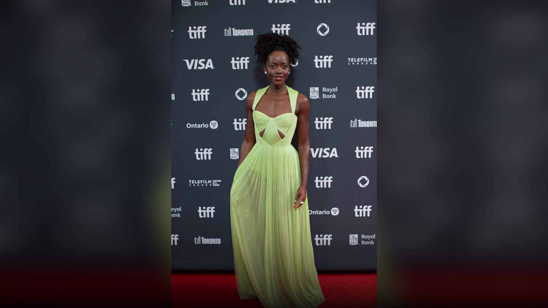 High-resolution portrait photograph of Lupita Nyong'o celebrating academic achievement.