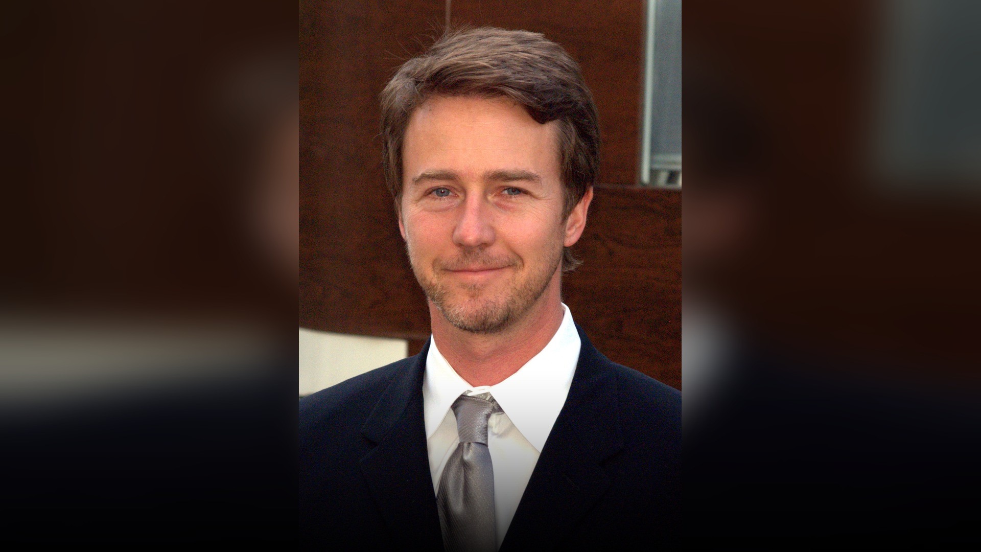 High-resolution portrait photograph of Edward Norton celebrating academic achievement.