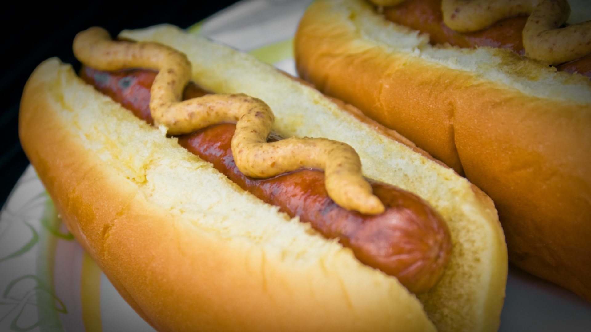 Grilled hot dogs on buns with mustard